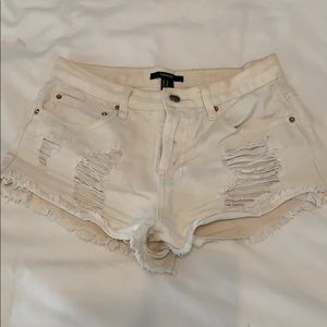 Distressed white jean shorts